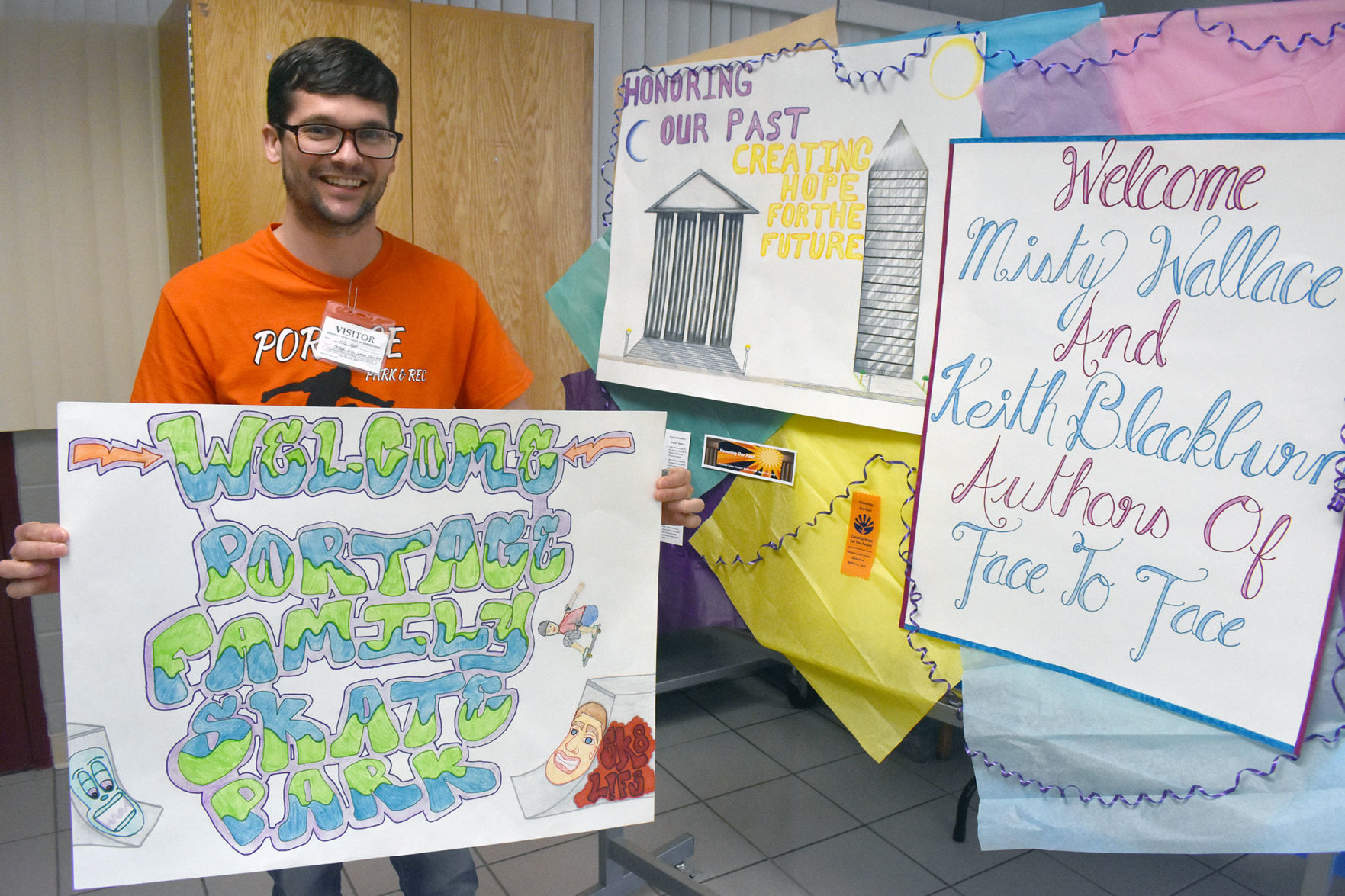 Kyle Little shows off poster inmates made for him
